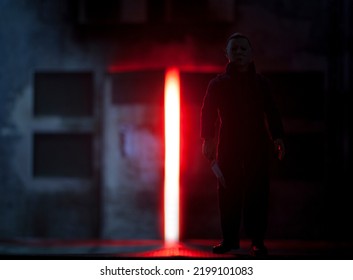 SEPT 5 2022: Halloween Film Franchise Slasher Michael Myers Looming With A Knife And Evil Red Background - Neca Action Figure 