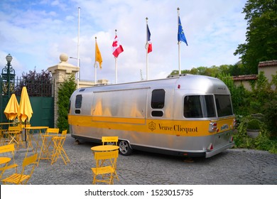 Sept 7, 2019, Reims, France. Outdoor area at the Veuve Clicquot Ponsardin Visitors Center. There is an Airstream Bar and tables and chairs. 