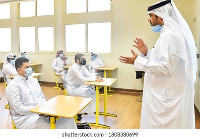 SEPTEMBER 01,2020-DOHA,QATAR:Students And Class Teacher Wearing Face Masks And Maintaining Social Distancing At A Classroom On The First Day Of School Reopening At A Secondary School In Doha,Qatar