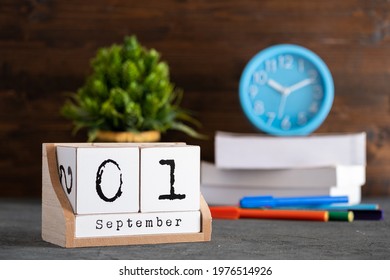 September 01st. September 01 wooden cube calendar with blur objects on background.