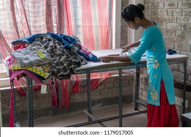 September 07,2018. Debanandapur, West Bengal. India. A Self Help group woman ironing the finished products.