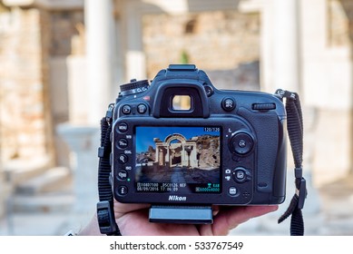 September 08,2016,Turkey,Selcuk,Ephesus Ancient City. Man Holding Nikon DSLR With Ruins Picture In Viewfinder