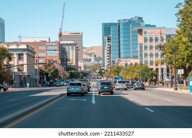 September 10, 2022, Salt Lake City, USA. Cars Moving On Road Leading Towards State Capitol. Traffic On Street Amidst Modern Buildings In City. View Of Urban Landscape With Clear Sky In Background.