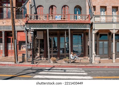 September 10, 2022, Virginia, USA. Tourist Sitting On Bench Outside Old Shop At Vintage City. Male Traveler Relaxing While Exploring Victorian Style Town During Summer Vacation.