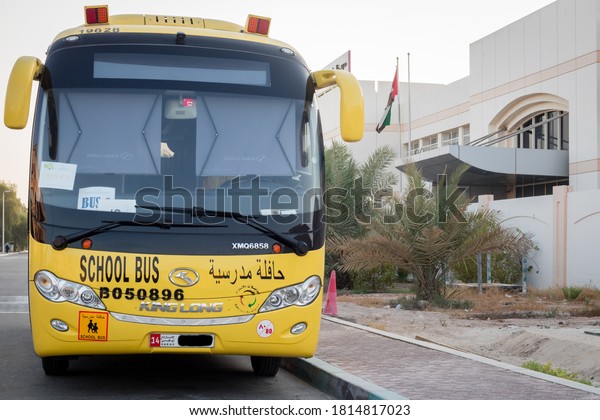 September 14-2020 in UAE. Yellow school bus in Abu\
Dhabi, United Arab Emirates, Dubai, Emirates, Gulf, Middle East.\
Awareness signs and symbol was written in arabic language at school\
bus.
