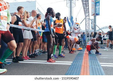 September 15, 2018 Minsk Belarus Half Marathon Minsk 2019 Marathon runners of different skin colors do a warm-up before starting - Shutterstock ID 1519590407
