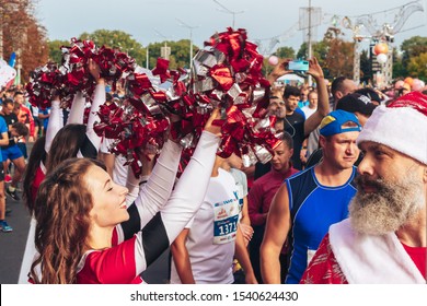 September 15, 2018 Minsk Belarus Half Marathon Minsk 2019 Cheerleaders are dancing next to a man with a beard in a suit of Santa Claus