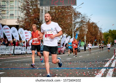 September 15, 2018 Minsk Belarus Half Marathon Minsk 2019 Marathon Runners Cross The Finish Line. From Above Hangs A Scoreboard With A Countdown.