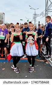 September 15, 2019 Minsk Belarus There are two Mature women Twins in carnival costumes standing before the start of the marathon