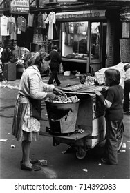 September 18,1975,Orchard Street,New York City.Boy Buying Pretzel From Cart Vendor