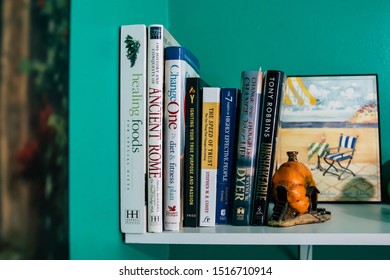 September 20, 2019 Cumberland Rhode Island USA. Book Shelf Educational And Self Help Book Stack Collection. Fairy And Weights Decorating Shelf.