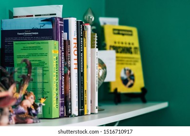 September 20, 2019 Cumberland Rhode Island USA. Book Shelf Educational And Self Help Book Stack Collection. Fairy And Weights Decorating Shelf.