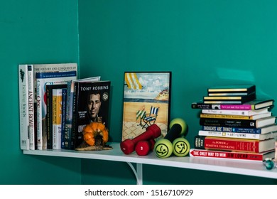 September 20, 2019 Cumberland Rhode Island USA. Book Shelf Educational And Self Help Book Stack Collection. Fairy And Weights Decorating Shelf.