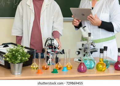 September, 2017 - Belarus, Minsk. Women Teacher And Teenager Student Are In Chemistry Class. Tey Make Test. STEM Education. Lego Mindstorm Robot, Mechanic, Chemistry, Biology. They Use Apple Ipad.