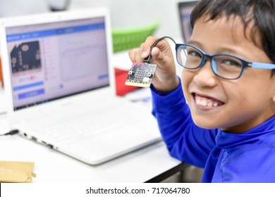 September, 2017. Phil The Young Asian Boy Enjoys His Micro Bit And Coding For Kids Classroom In Thailand.