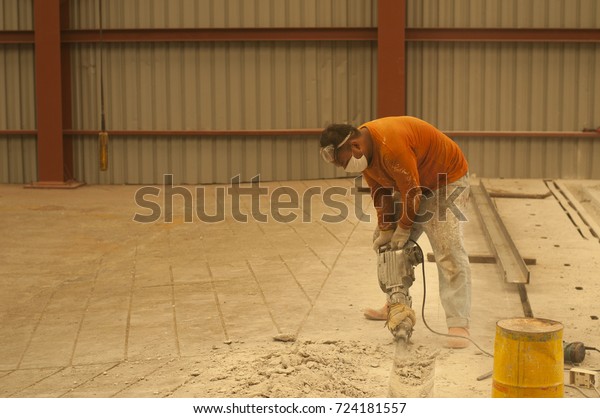 September 2017 Unskilled Worker Breaking Concrete Stock Photo