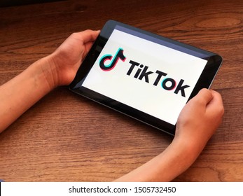 September 2019 Parma, Italy: Tablet In Kids Hands With Tik Tok Downloaded On Screen. Tik Tok App