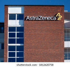 Södertälje/Sweden - September 2020: Signboard with name of the pharmaceutical company AstraZeneca with logo on a big wall of red bricks at the manufacturing site.