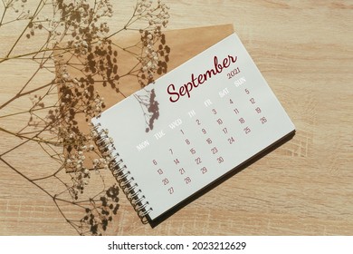 September 2021. Calendar for full month. Notebook for writing on spring next to a sprig of gypsophila flowers. Autumn month. Concept of time planning.