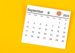 September 2023 And Wooden Push Pin On Yellow Background.