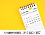 September 2024 Monthly desk calendar for 2024 year with thumbtack on yellow background.