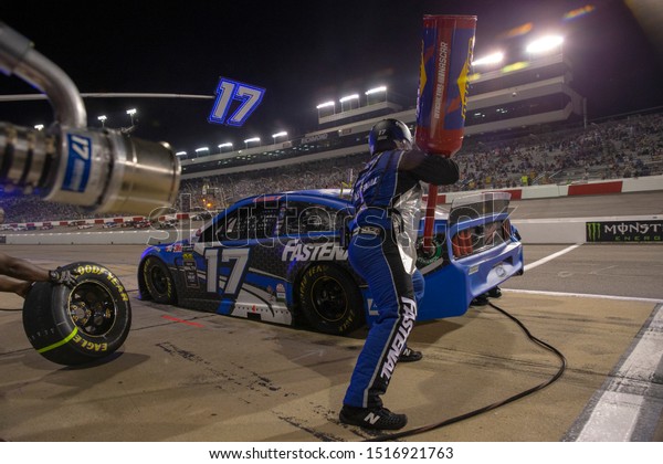 September\
21, 2019 - Richmond, Virginia, USA: Ricky Stenhouse, Jr (17) and\
crew make a pit stop under the lights for the Federated Auto Parts\
400 at Richmond Raceway in Richmond,\
Virginia.