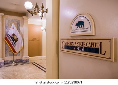 September 22, 2018 Sacramento / CA / USA - California State Capitol Museum Sign Inside The Capitol State Building; The California Republic Flag On The Left