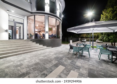 September 23, 2020 Uzhhorod, Street Горова. New Designer Loft Style Cafe. Night Photos Of The Institution. Exterior Photo With Tables And Umbrellas. There Is Noise In The Photo