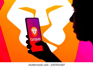 September 28, 2022, Brazil. In This Photo Illustration, A Silhouetted Woman Holds A Smartphone With The Brave Logo Displayed On The Screen