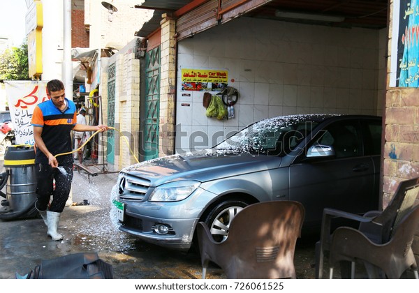 September 29 , 2017-Cairo, Egypt: Worker washing\
car at a car wash in\
Egypt