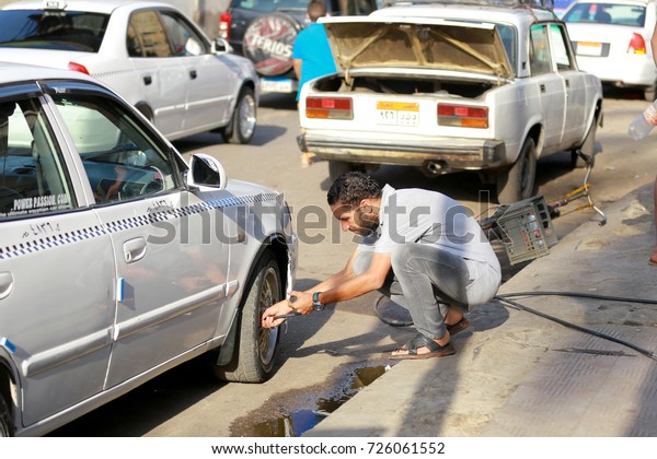September 29 , 2017-Cairo,
Egypt: A worker putting some air into a tire at a tire shop in
Cairo, Egypt
