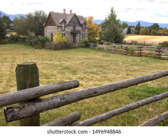 September 30, 2017. Bozeman, MT, USA. Stately Vintage Log Home With Wooden Log Property Fence In Big Sky Country.