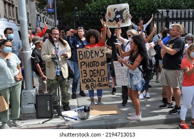 September11, 2021: Afro American Woman Holding Up Protest Sign And Given The Victory Sign With Her Hand. Crowd Of People Around Her In Protest Across The Street At The World Trade Center On 9 11 2021.