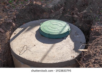 Septic tank made of concrete rings with a hatch for a private country house. Wastewater and sewerage drainage.