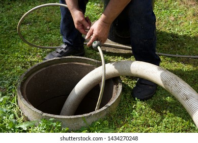 Septic tank: the removal of sewage sludge and cleaning of a domestic septic tank at rural French home.