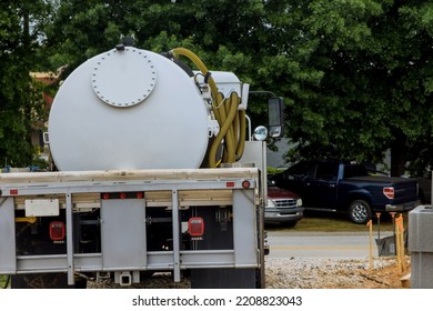 Septic Truck In Cleaning Portable Restroom On Construction Site