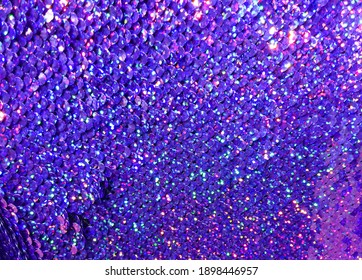 Sequins close-up macro. Abstract background with sequins blue on the fabric.