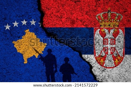 Serbia and Republic of Kosovo flags background. Cracked wall. Military conflict and war concept 
