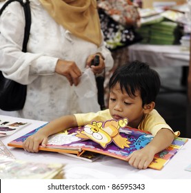 SERDANG, MALAYSIA - OCTOBER 9: Unidentified kid at the Big Bad Wolf book fair on October 9, 2011 in Malaysia Agro Exposition Park Serdang, Malaysia. The book fair is the world biggest with 1.5m title