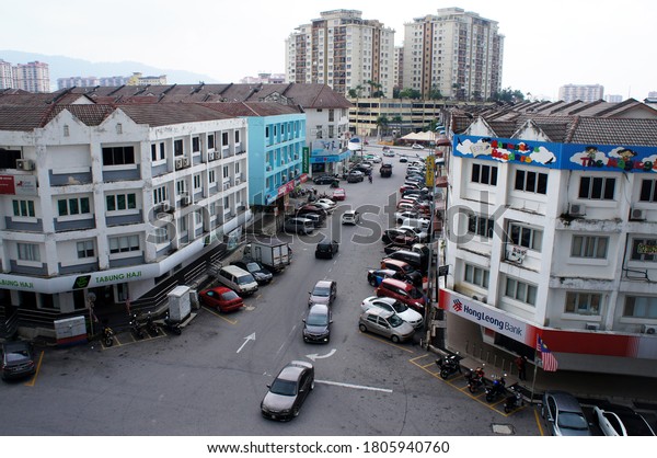 SEREMBAN,\
MALAYSIA - AUGUST 31, 2020: Shop lots at the commercial area. The\
front facade is decorated with business ads to attract customers.\
Provided car park at the front for\
customers.