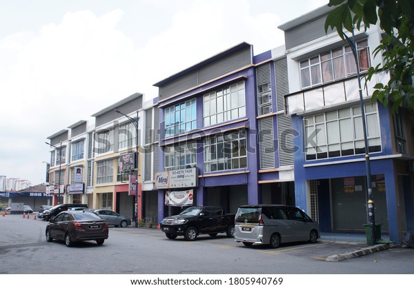 SEREMBAN,\
MALAYSIA - AUGUST 31, 2020: Shop lots at the commercial area. The\
front facade is decorated with business ads to attract customers.\
Provided car park at the front for\
customers.