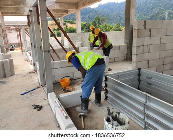 SEREMBAN, MALAYSIA -MARCH 16, 2020: Construction workers laying autoclaved aerated concrete block at the construction site. The use of this material can save time and facilitate construction work.