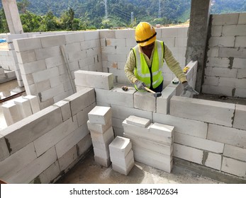 SEREMBAN, MALAYSIA -MARCH 17, 2020: Blockwork by construction workers at the construction site. Workers laying the AAC brick and stacked it together using mortar to form the wall. 
