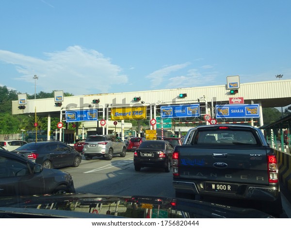 SEREMBAN, MALAYSIA -MAY 26,\
2020: Highway toll canopy in Malaysia. Vehicles that use the\
expressway through a toll plaza and make payments each time they\
enter and exit.