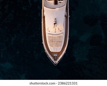 Serene Aerial View of Man Contemplating the Ocean on a Private Yacht Deck - Powered by Shutterstock