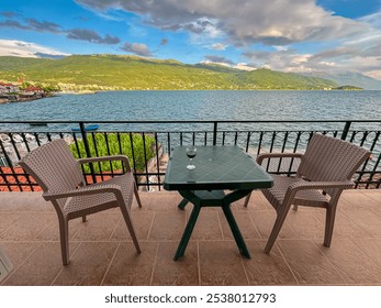 Serene balcony overlooking a picturesque lake Ohrid, North Macedonia. Small table and two chairs offer a cozy spot to relax and enjoy the stunning view in summer in Balkans. National Park Galicica - Powered by Shutterstock