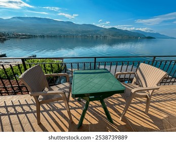 Serene balcony overlooking a picturesque lake Ohrid, North Macedonia. Small table and two chairs offer a cozy spot to relax and enjoy the stunning view in summer in Balkans. National Park Galicica - Powered by Shutterstock