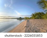 Serene beach landscape on the shores of Lake Tanganyika, Zambia, Africa. Blue skies and calm waters at sunrise.