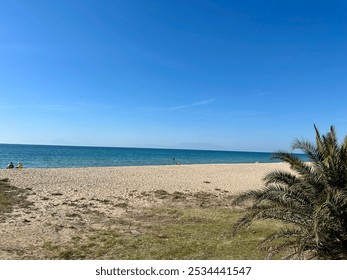 A serene beach scene in Nea Moudania (Chalkidiki, Greece)  with clear blue skies, golden sand, calm turquoise waters, and a distant mountain range on the horizon. - Powered by Shutterstock