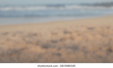 A serene beach scene with soft focus on the sand and the ocean waves gently rolling in.